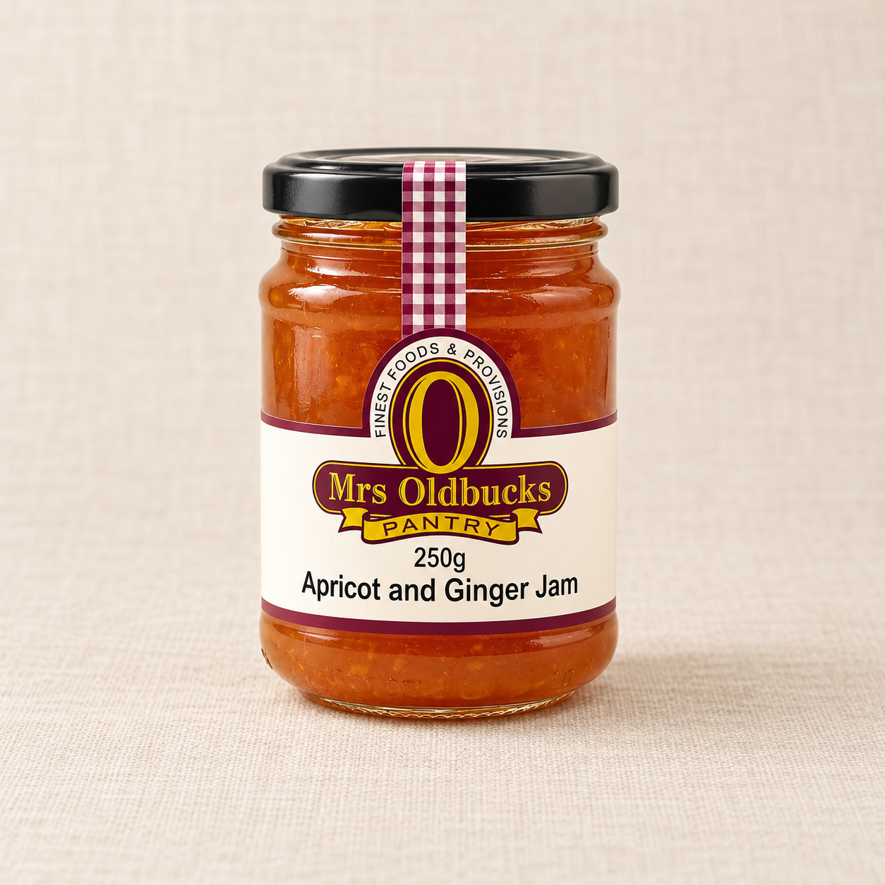 Mrs Oldbucks Pantry Apricot and Ginger Jam 250g glass jar on a warm beige linen background