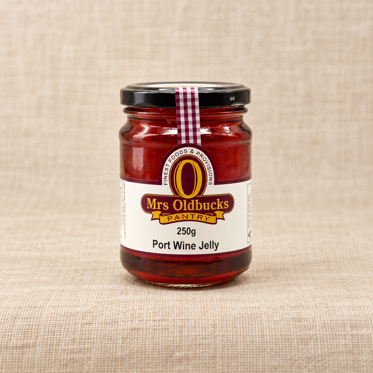 Mrs Oldbucks Pantry Port Wine Jelly 250g jar on a warm beige linen background