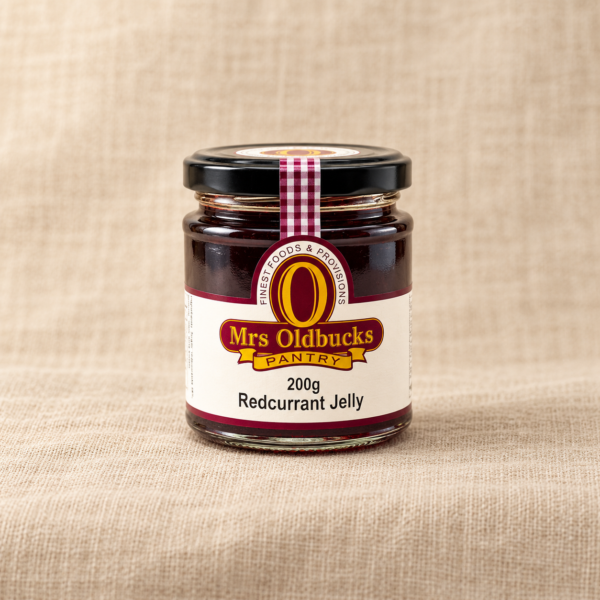 Mrs Oldbucks Pantry Redcurrant Jelly 200g jar on a warm beige linen background