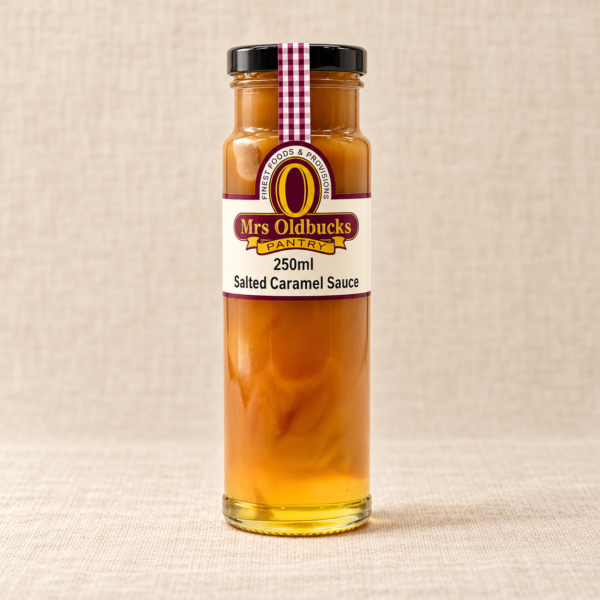 Mrs Oldbucks Pantry Salted Caramel Sauce 250 ml glass bottle with a black lid on a warm beige linen background.