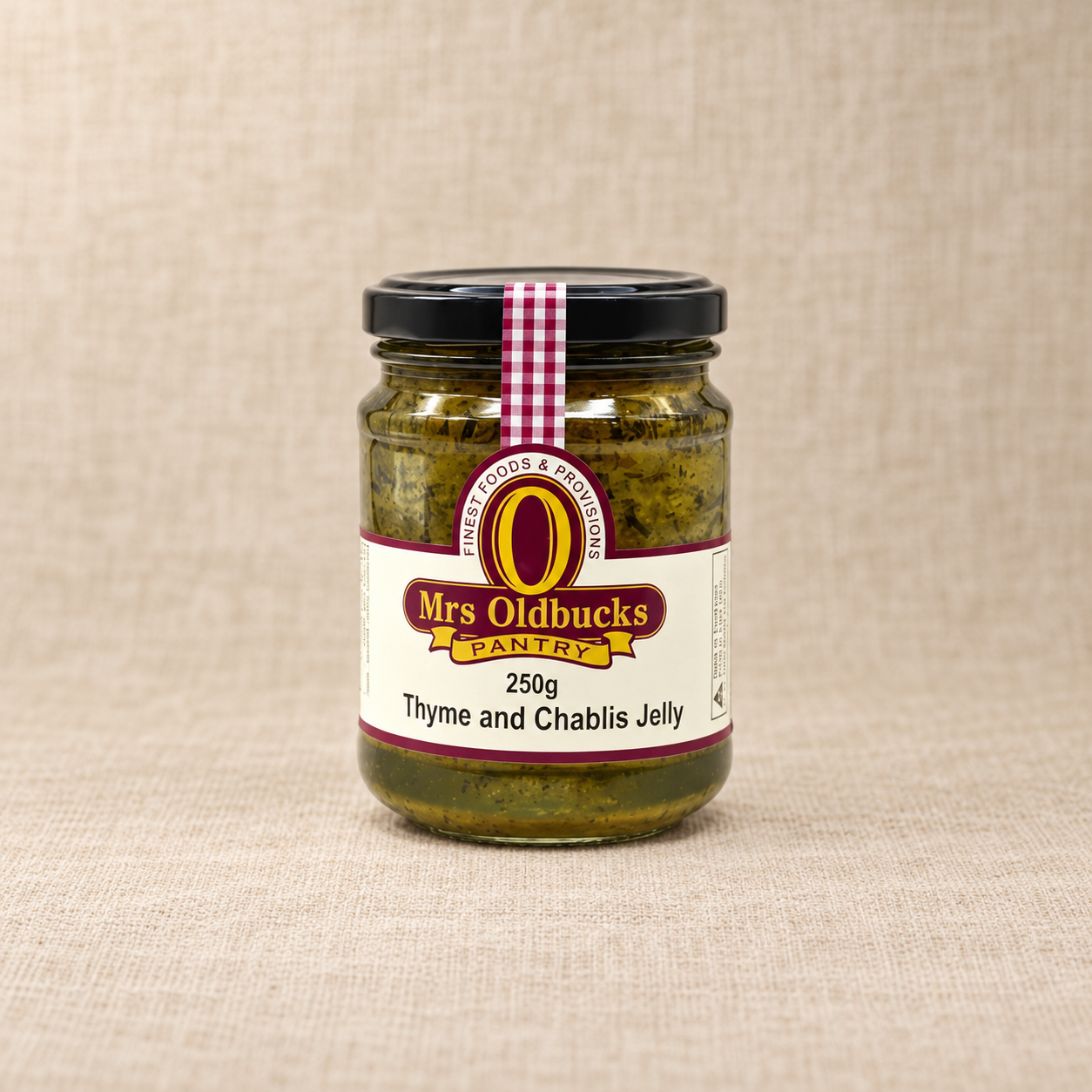 Mrs Oldbucks Pantry Thyme and Chablis Jelly 250g jar on a warm beige linen background