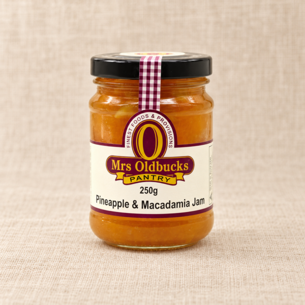 Mrs Oldbucks Pantry Pineapple and Macadamia Jam 250g jar on a warm beige linen background