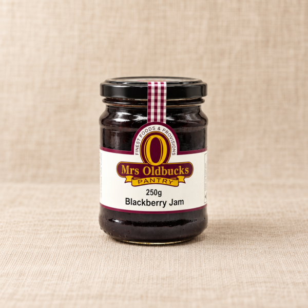 Mrs Oldbucks Pantry Blackberry Jam 250g jar on a warm beige linen background