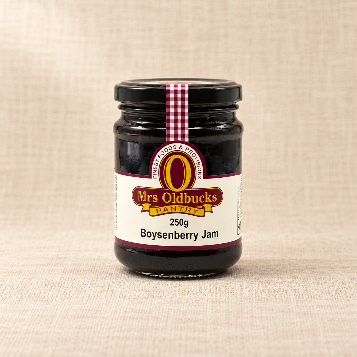 Mrs Oldbucks Pantry Boysenberry Jam 250g jar on a warm beige linen background