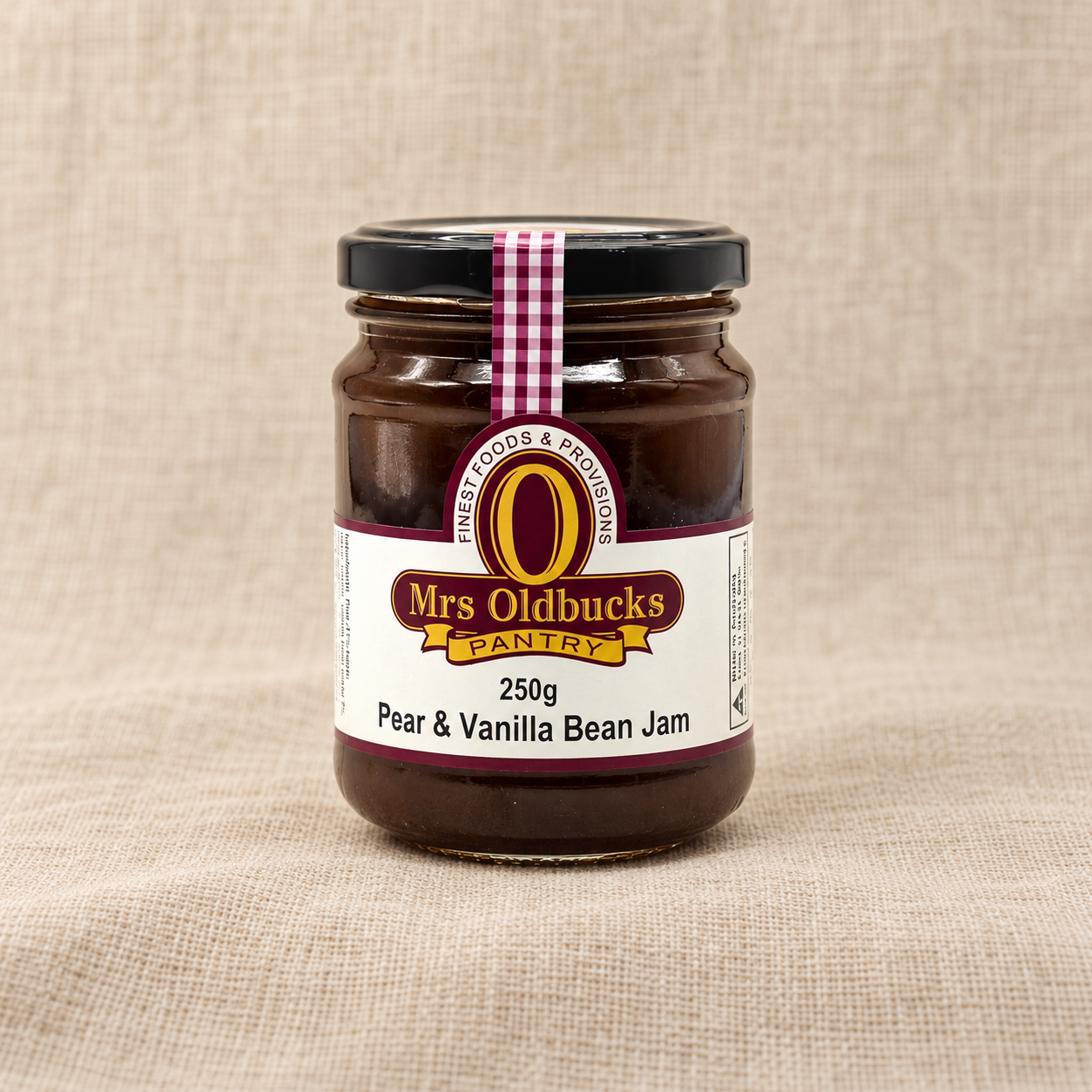 Mrs Oldbucks Pantry Pear and Vanilla Bean Jam 250g jar on a warm beige linen background