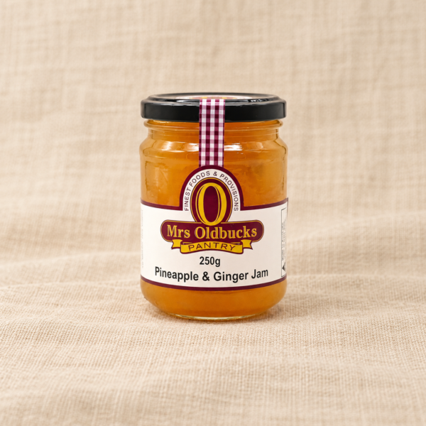 Mrs Oldbucks Pantry Pineapple and Ginger Jam 250g jar on a warm beige linen background
