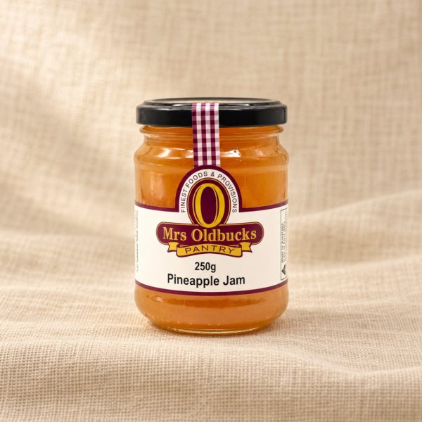 Mrs Oldbucks Pantry Pineapple Jam 250g jar on a warm beige linen background