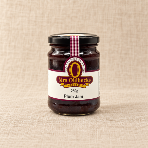 Mrs Oldbucks Pantry Plum Jam 250g jar on a warm beige linen background