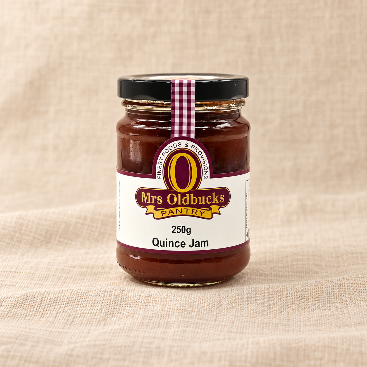 Mrs Oldbucks Pantry Quince Jam 250g jar on a warm beige linen background