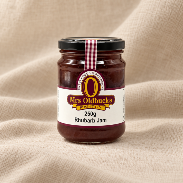 Mrs Oldbucks Pantry Rhubarb Jam 250g jar on a warm beige linen background