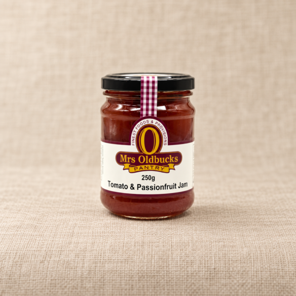 Mrs Oldbucks Pantry Tomato and Passionfruit Jam 250g jar on a warm beige linen background