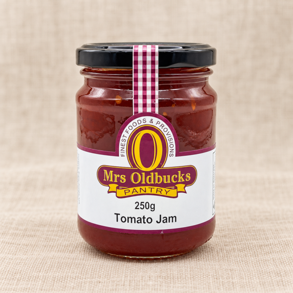 Mrs Oldbucks Pantry Tomato Jam 250g jar on a warm beige linen background