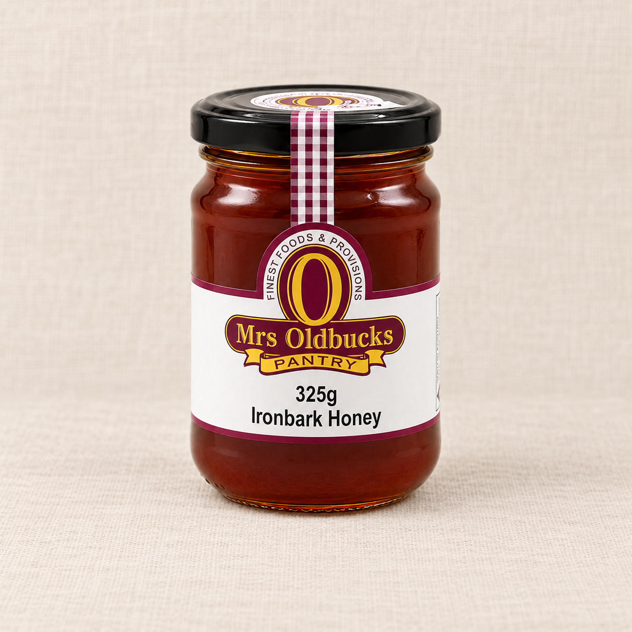 Mrs Oldbucks Pantry Ironbark Honey 325g jar on a warm linen background