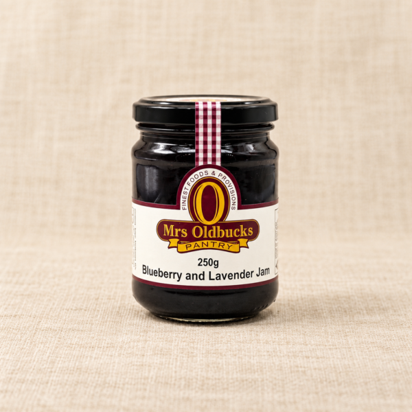 Mrs Oldbucks Pantry Blueberry and Lavender Jam 250g jar on a warm beige linen background