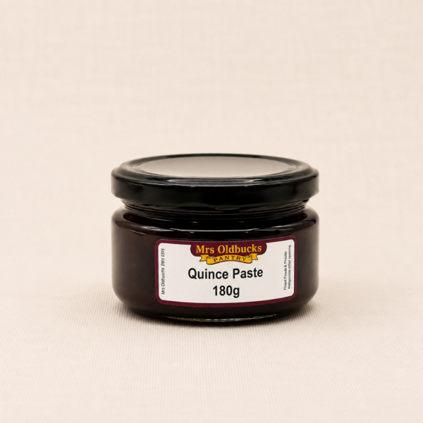 Mrs Oldbucks Pantry Quince Paste 180g in a glass jar on a soft linen background. Traditional gourmet fruit paste for cheese boards, grazing platters and entertaining.