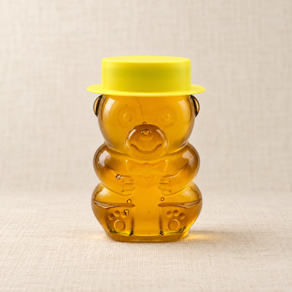 Bear-shaped squeeze bottle filled with golden Australian Stringybark honey