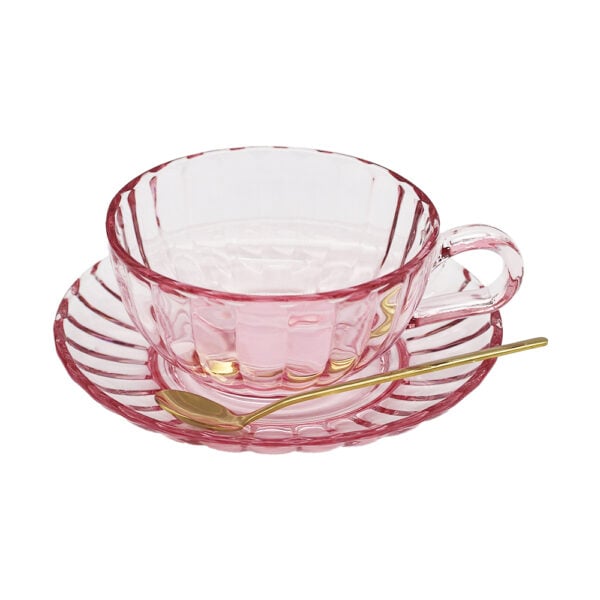 Mrsoldbuckspantrymaisyglassteacupsetpink Light pink glass tea cup and saucer set with textured finish and gold spoon, styled on a soft neutral background