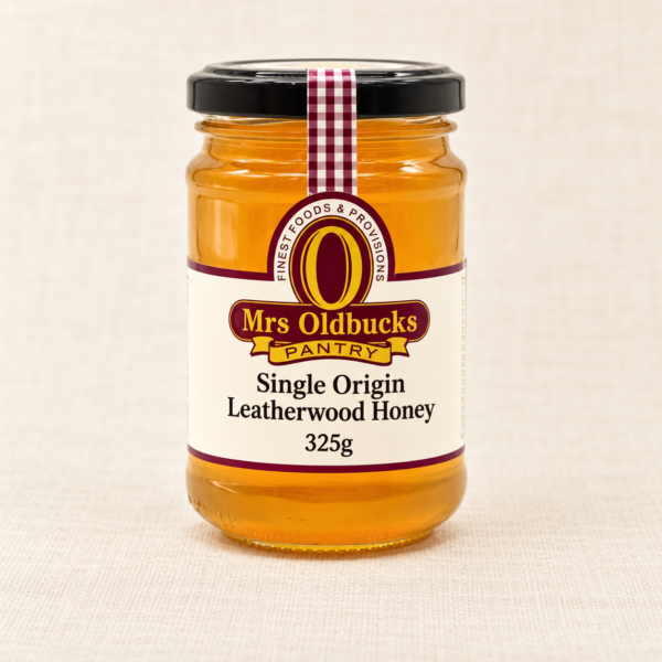 Mrs Oldbucks Pantry Single Origin Leatherwood Honey 325g glass jar on a warm beige linen background