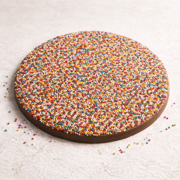 Mrs Oldbucks Pantry Giant Milk Chocolate Freckle250g milk chocolate giant freckle topped with colourful candy sprinkles on a soft off-white background, large round chocolate confection perfect for gifting and sharing.