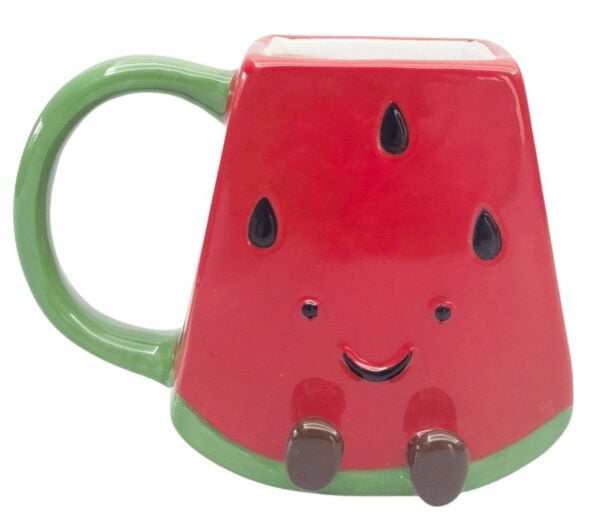 Mrs Oldbucks Pantry Winnie Watermelon Mug Watermelon slice-shaped ceramic mug with red body, black seed detail, green trim and handle, smiling face and small brown feet on a white background.
