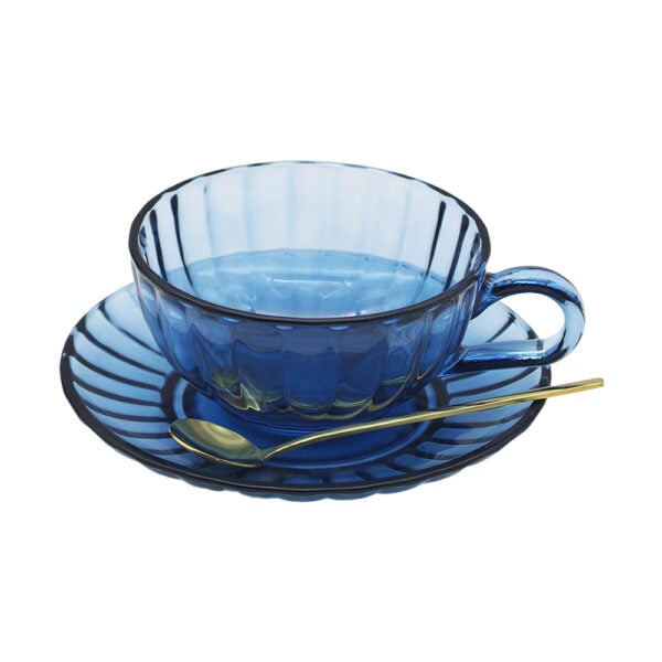 Mrsoldbuckspantrymaisyglassteacupsetdustyblue Blue glass tea cup and saucer set with textured finish and gold spoon, styled on a soft neutral background